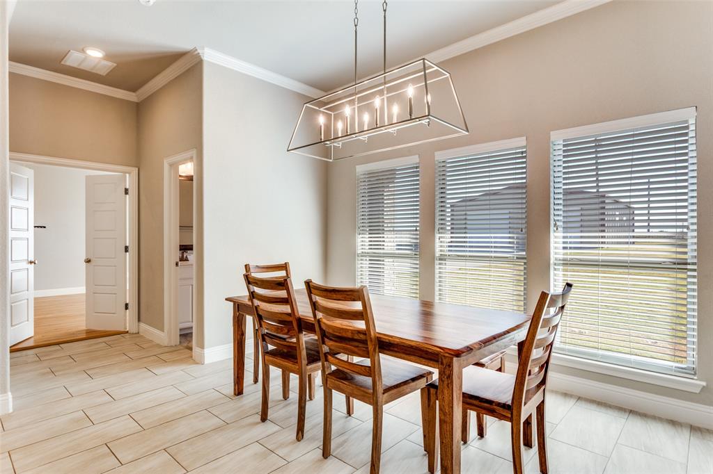 14717 Lost Wagon Street Justin, TX 76247 - Photo 16 of 37 a view of a dining room with furniture and chandelier