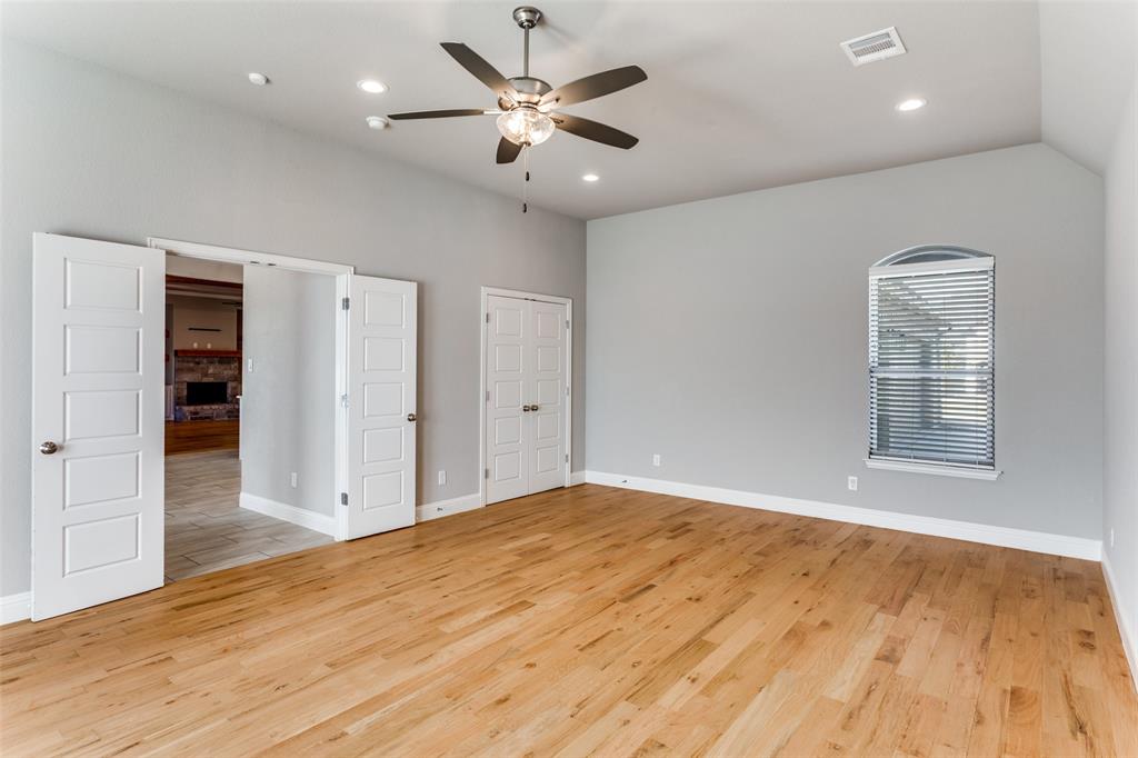 14717 Lost Wagon Street Justin, TX 76247 - Photo 18 of 37 a view of an empty room with a window and wooden floor