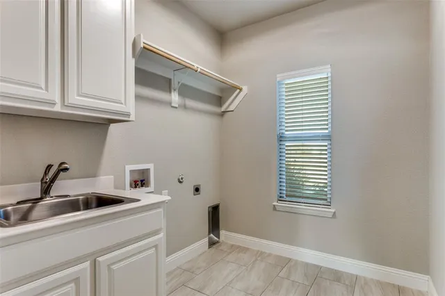 a kitchen with a sink cabinets and window