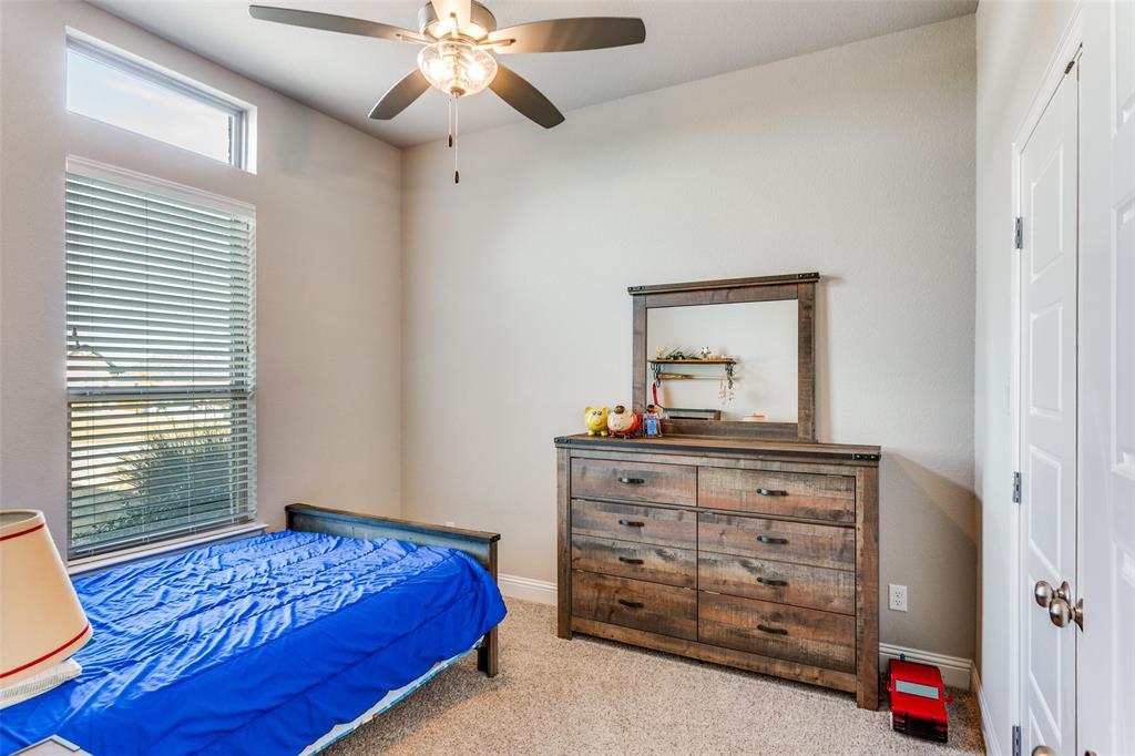 14717 Lost Wagon Street Justin, TX 76247 - Photo 27 of 37 a bedroom with a bed and a dresser