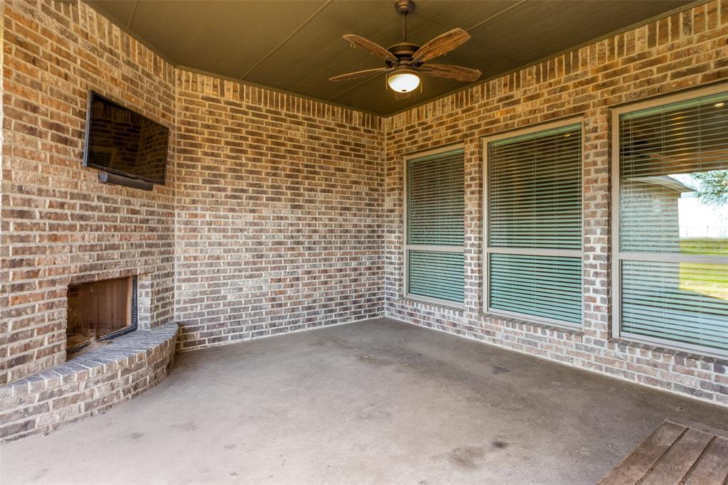 14717 Lost Wagon Street Justin, TX 76247 - Photo 31 of 37 a view of an empty room with a fireplace and a window