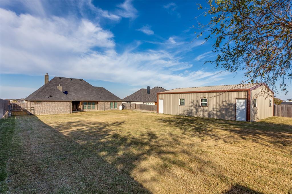 14717 Lost Wagon Street Justin, TX 76247 - Photo 35 of 37 a view of a large house with a yard