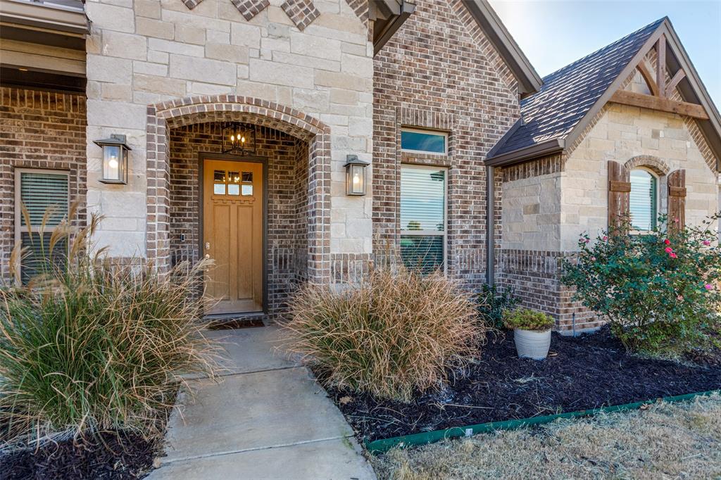 14717 Lost Wagon Street Justin, TX 76247 - Photo 4 of 37 a front view of a house with a garden