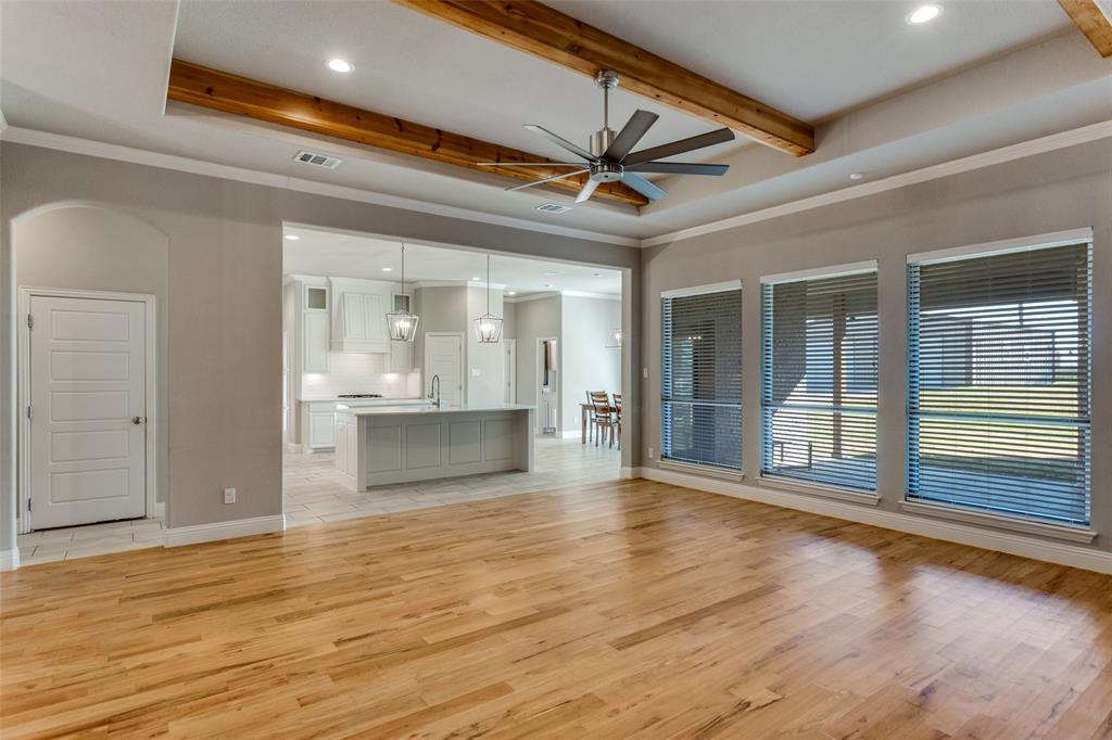 14717 Lost Wagon Street Justin, TX 76247 - Photo 8 of 37 a view of an empty room with wooden floor and a window