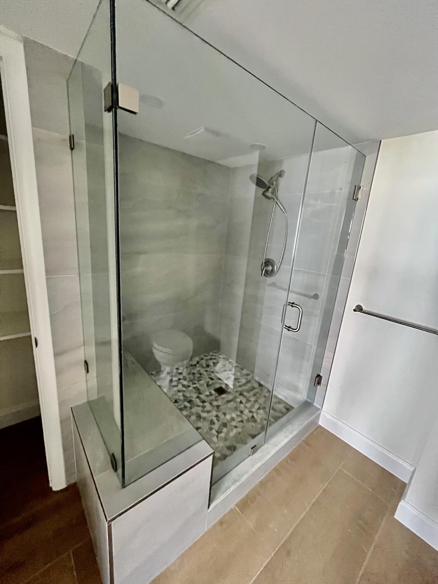 4200 North Ocean Drive, Unit 11601 Singer Island, FL 33404 - Photo 21 of 56 a bathroom with a glass shower door