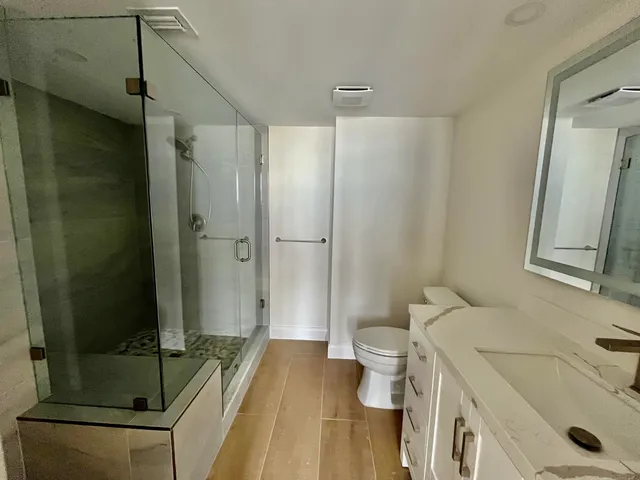 a kitchen with granite countertop a sink a stove and cabinets