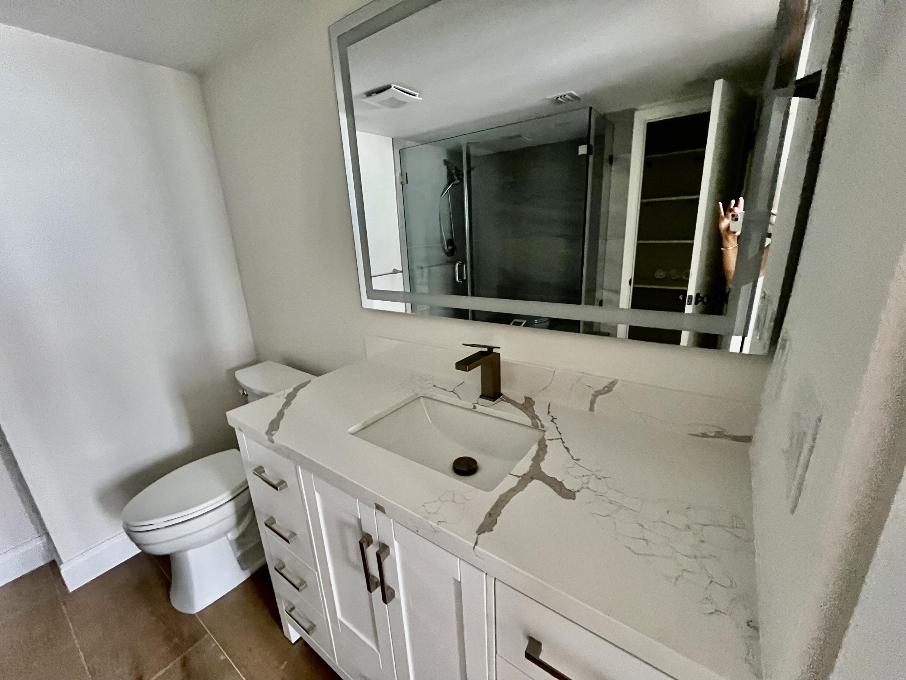 4200 North Ocean Drive, Unit 11601 Singer Island, FL 33404 - Photo 23 of 56 a bathroom with a sink and a toilet