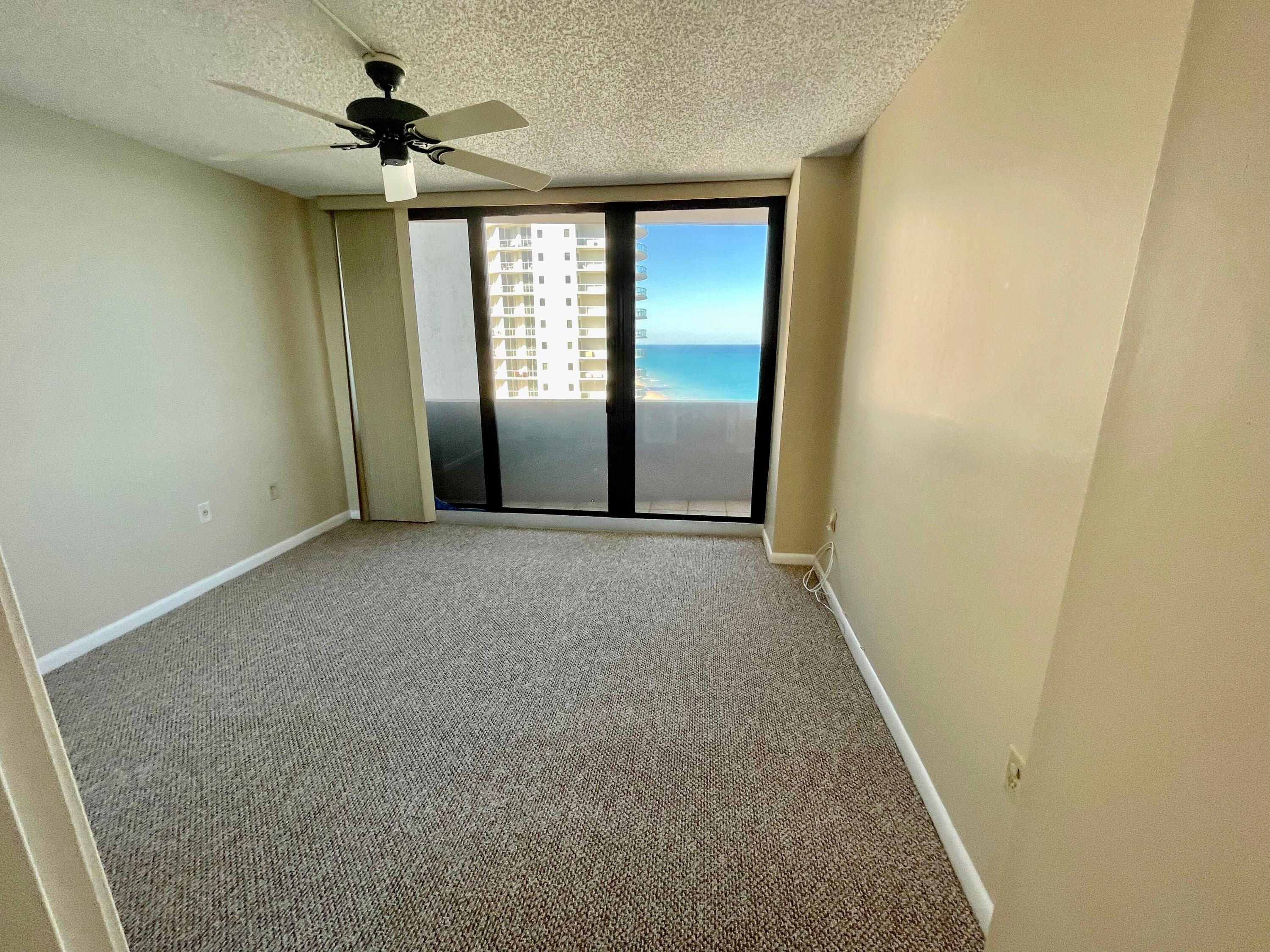 4200 North Ocean Drive, Unit 11601 Singer Island, FL 33404 - Photo 29 of 56 an empty room with windows and fan