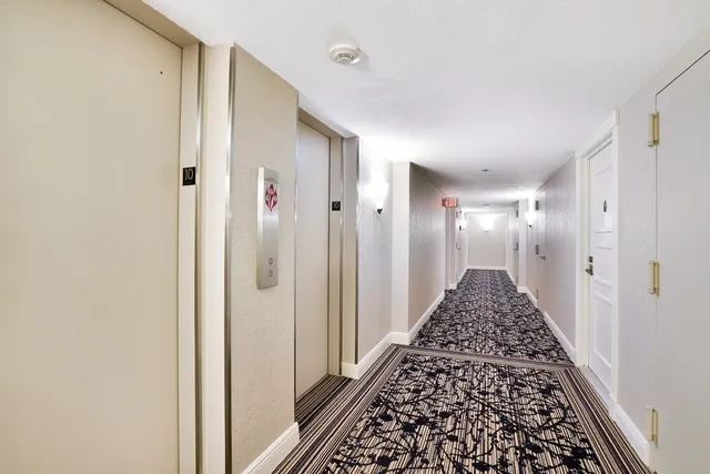 a view of backyard with a table and chairs and potted plants