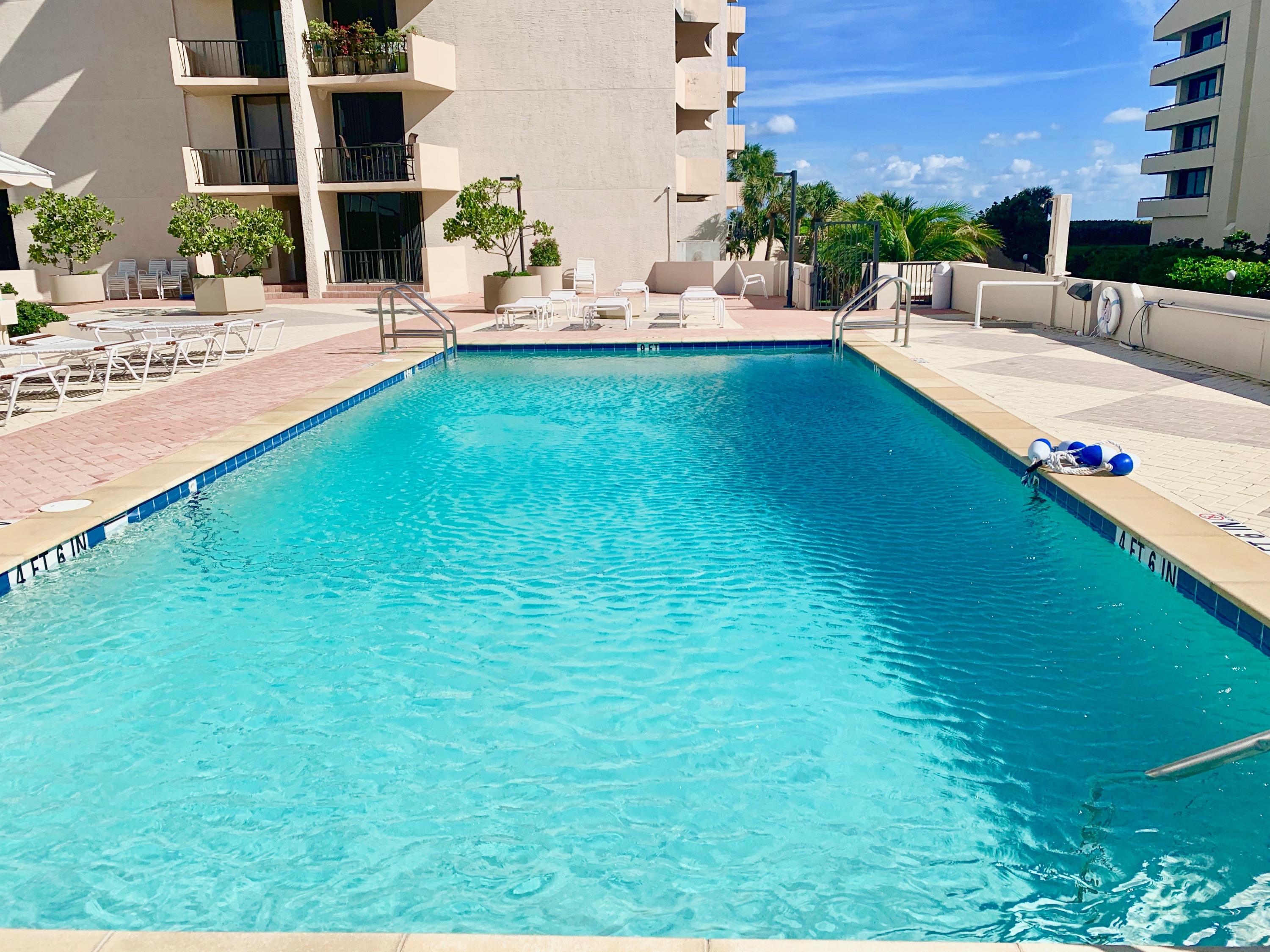 4200 North Ocean Drive, Unit 11601 Singer Island, FL 33404 - Photo 36 of 56 a swimming pool with outdoor seating and yard