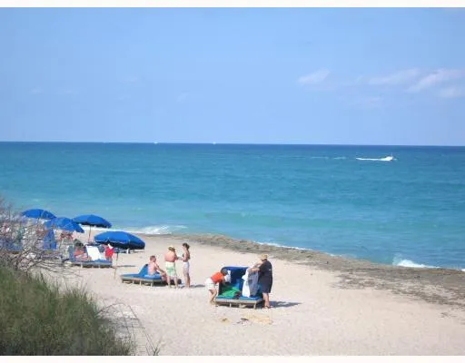 a swimming pool with a glass top table and chairs