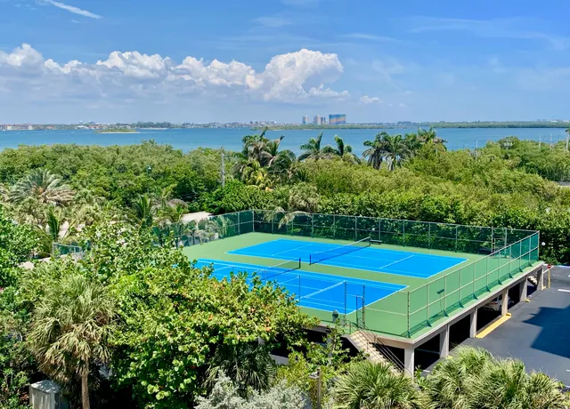 a living room with furniture a dining table and a floor to ceiling window
