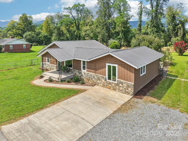 a aerial view of a house with a yard and sitting area