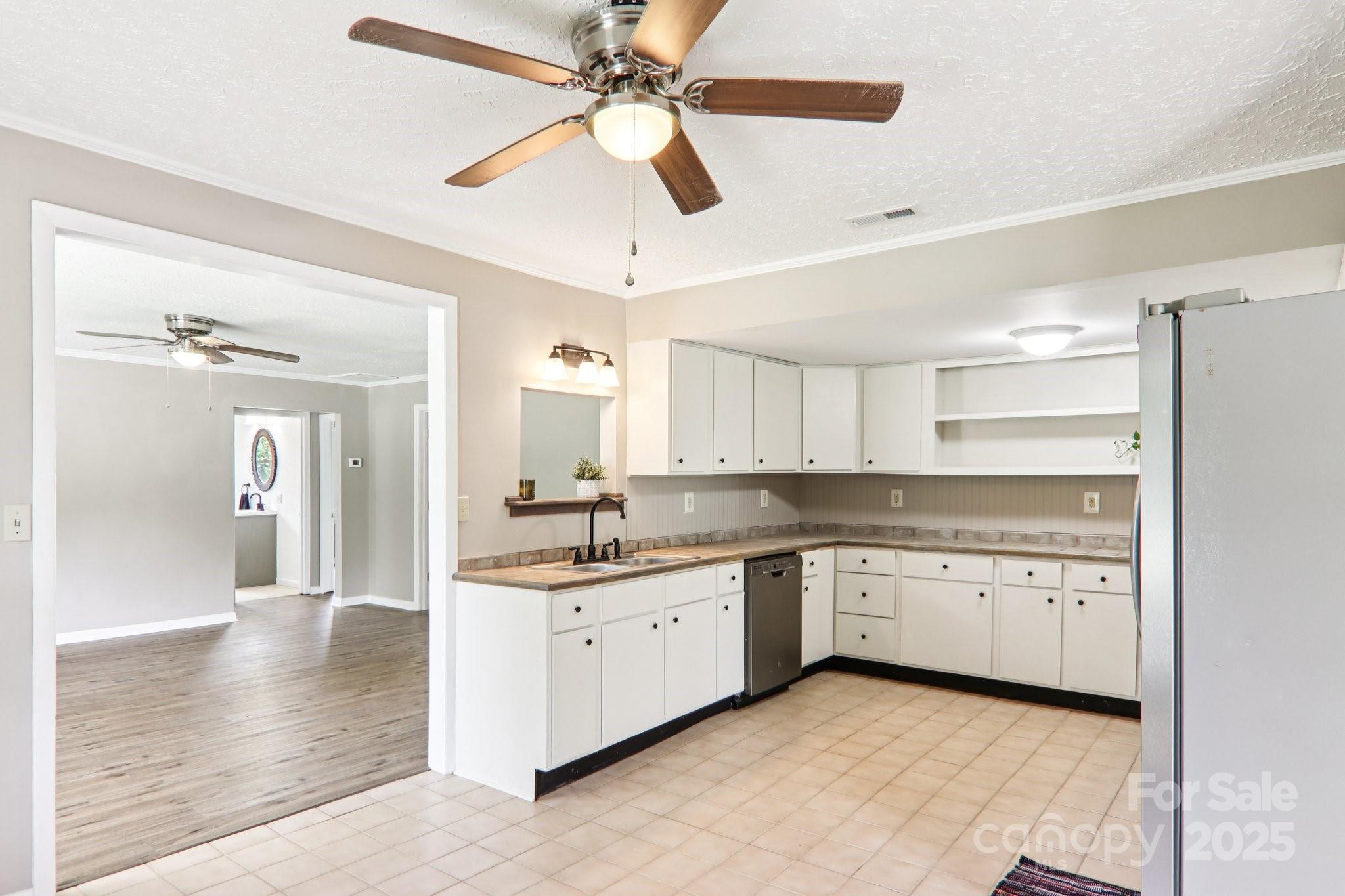 55 Polk Street Waynesville, NC 28786 - Photo 15 of 44 a kitchen with a sink a stove and cabinets