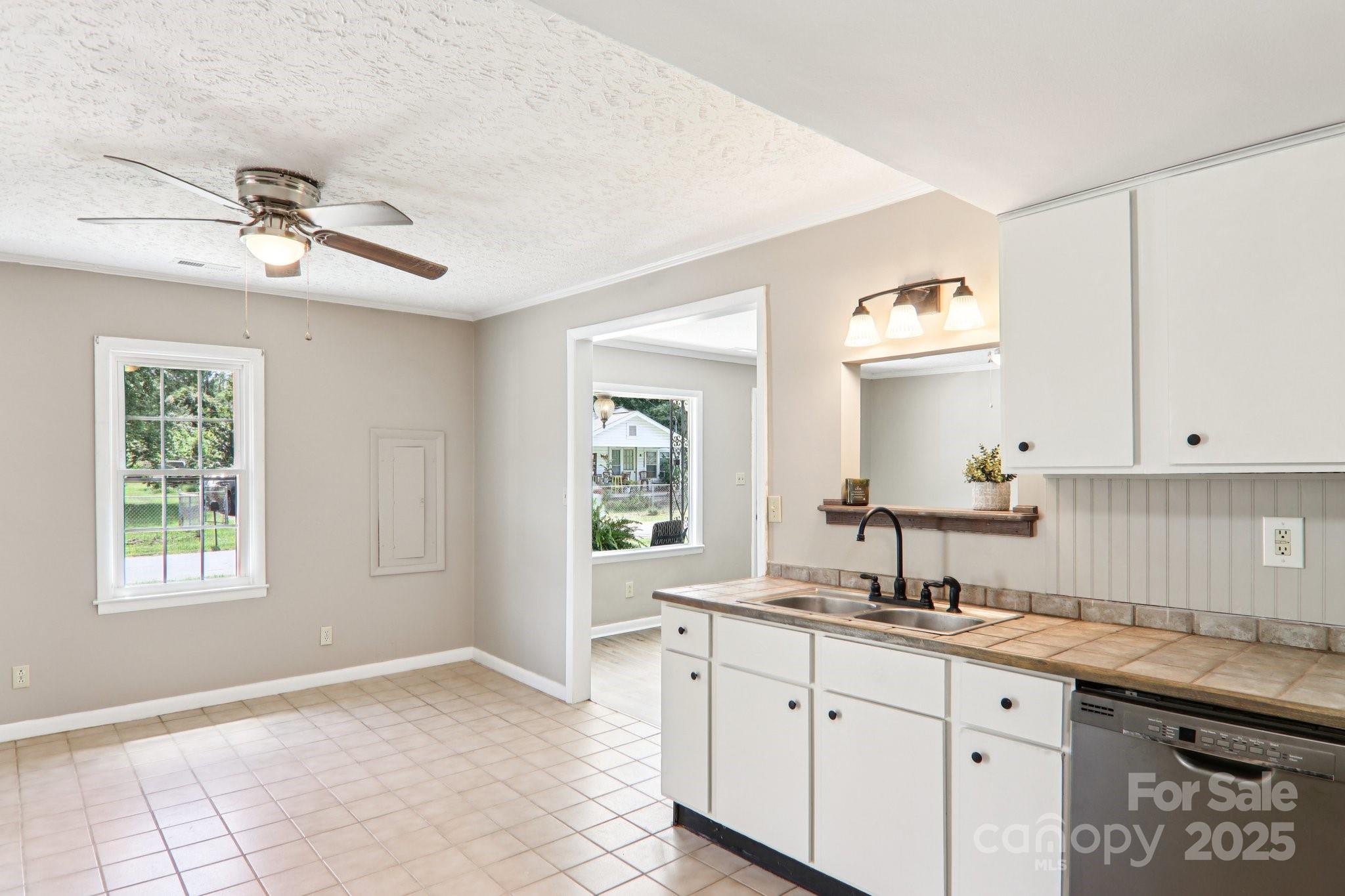 55 Polk Street Waynesville, NC 28786 - Photo 18 of 44 a kitchen with granite countertop a sink cabinets and window