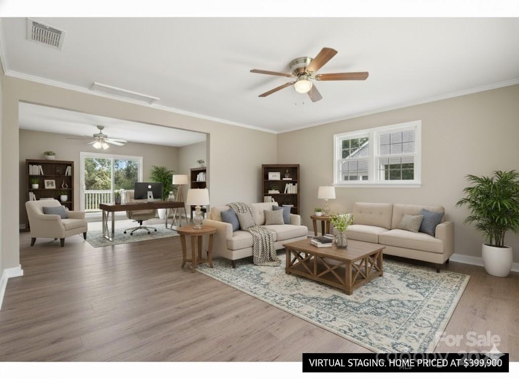 55 Polk Street Waynesville, NC 28786 - Photo 20 of 44 a living room with couches and a potted plant with wooden floor