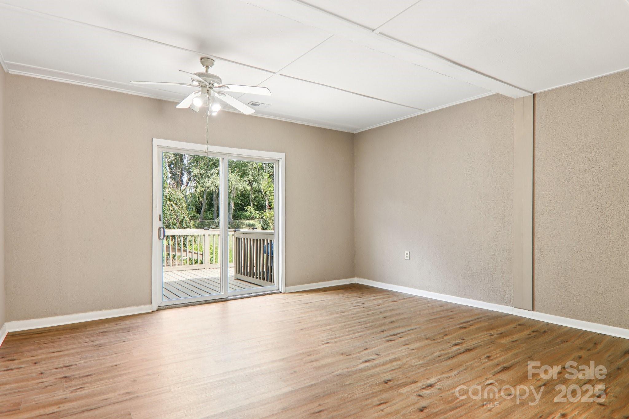 55 Polk Street Waynesville, NC 28786 - Photo 23 of 44 a view of an empty room with wooden floor and a window