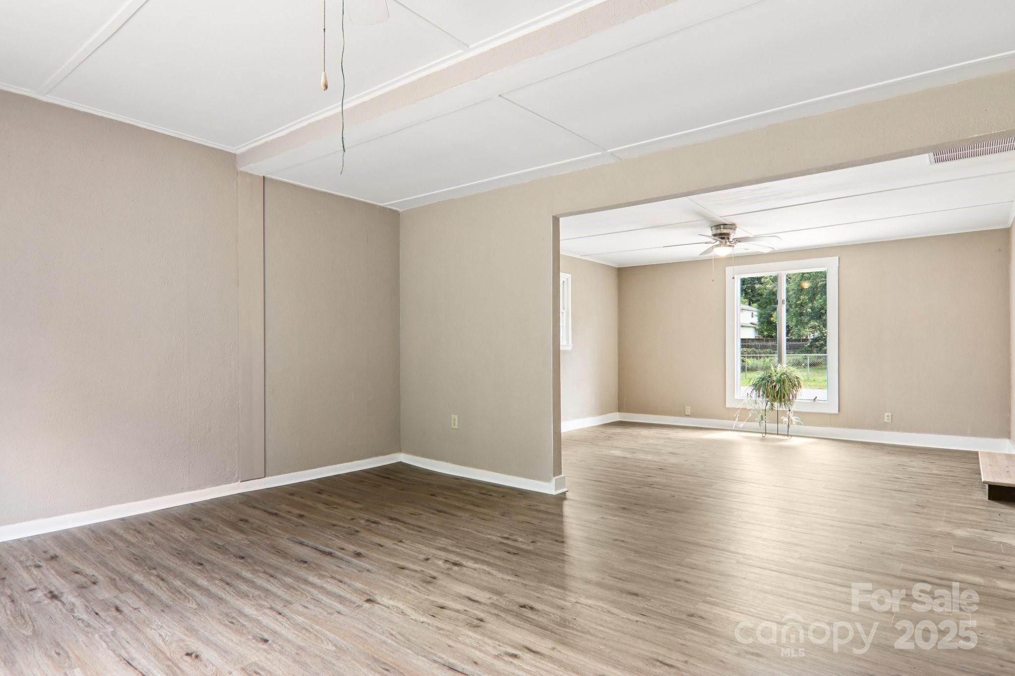 55 Polk Street Waynesville, NC 28786 - Photo 24 of 44 a view of an empty room with wooden floor and a window