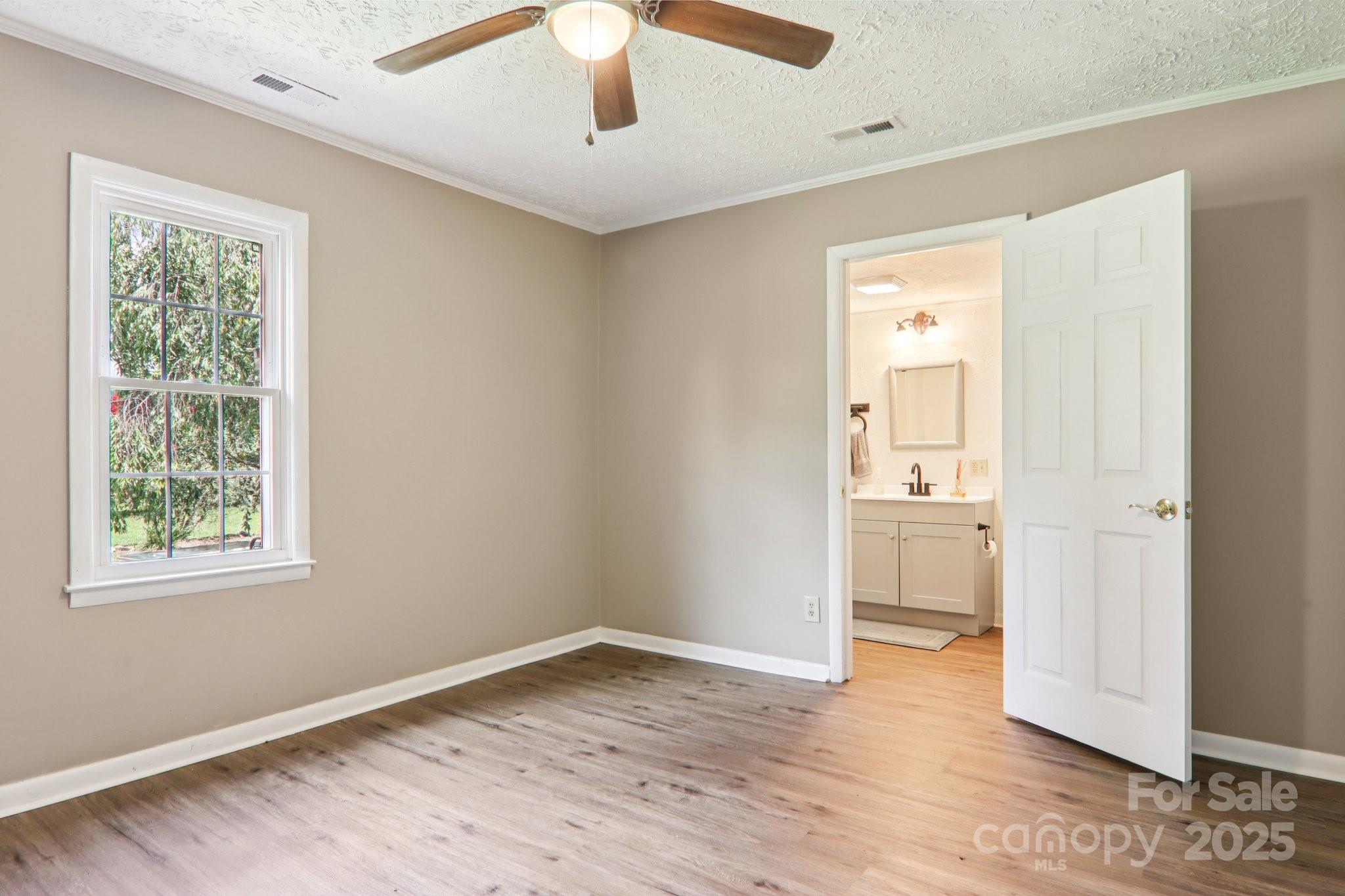 55 Polk Street Waynesville, NC 28786 - Photo 26 of 44 a view of an empty room with wooden floor and a window