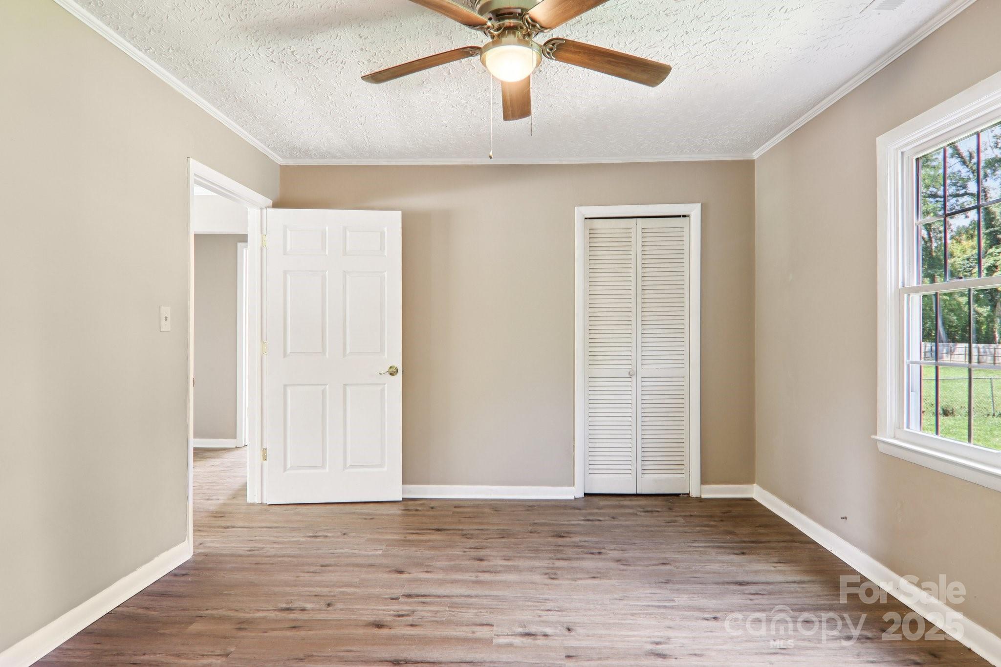 55 Polk Street Waynesville, NC 28786 - Photo 28 of 44 wooden floor in an empty room with a window