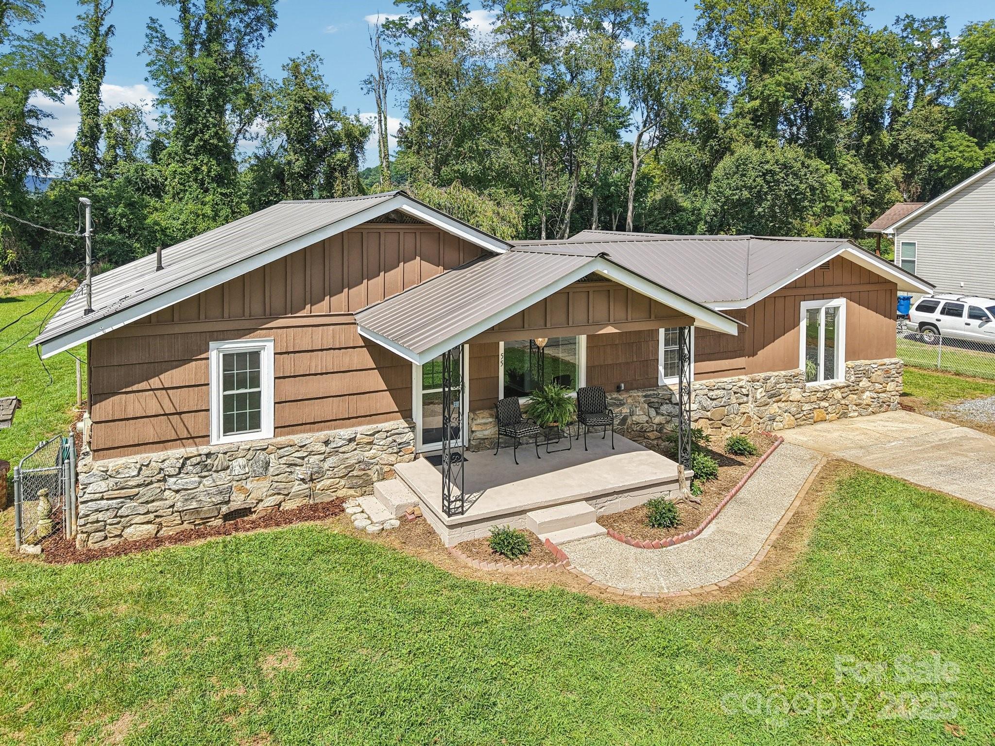 55 Polk Street Waynesville, NC 28786 - Photo 38 of 44 a view of a house with a yard and sitting area