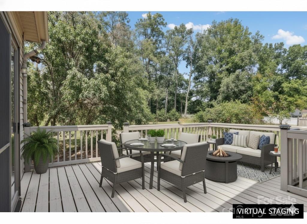 55 Polk Street Waynesville, NC 28786 - Photo 40 of 44 a balcony with wooden floor table and chairs