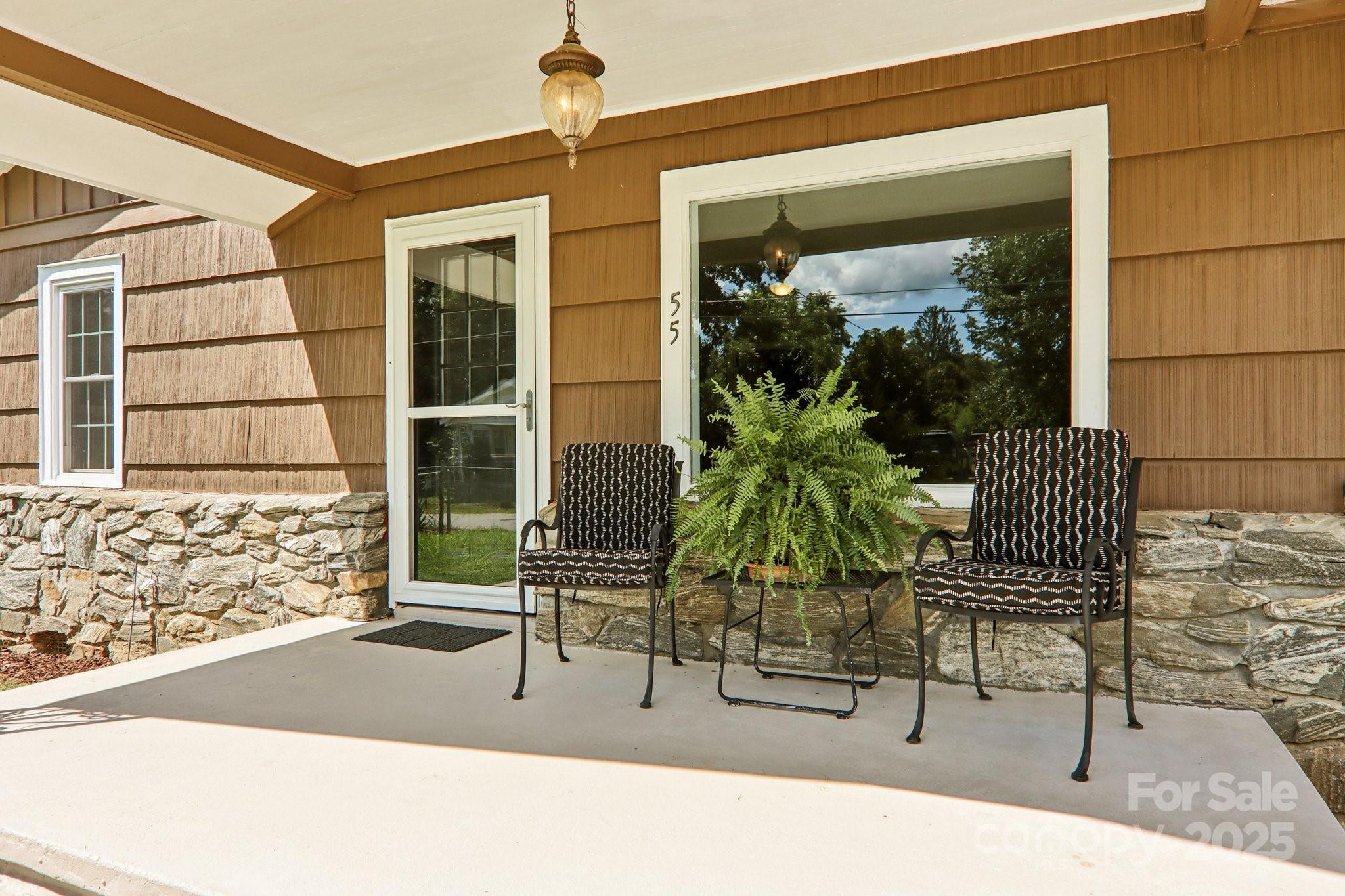 55 Polk Street Waynesville, NC 28786 - Photo 4 of 44 a building outdoor space with patio furniture