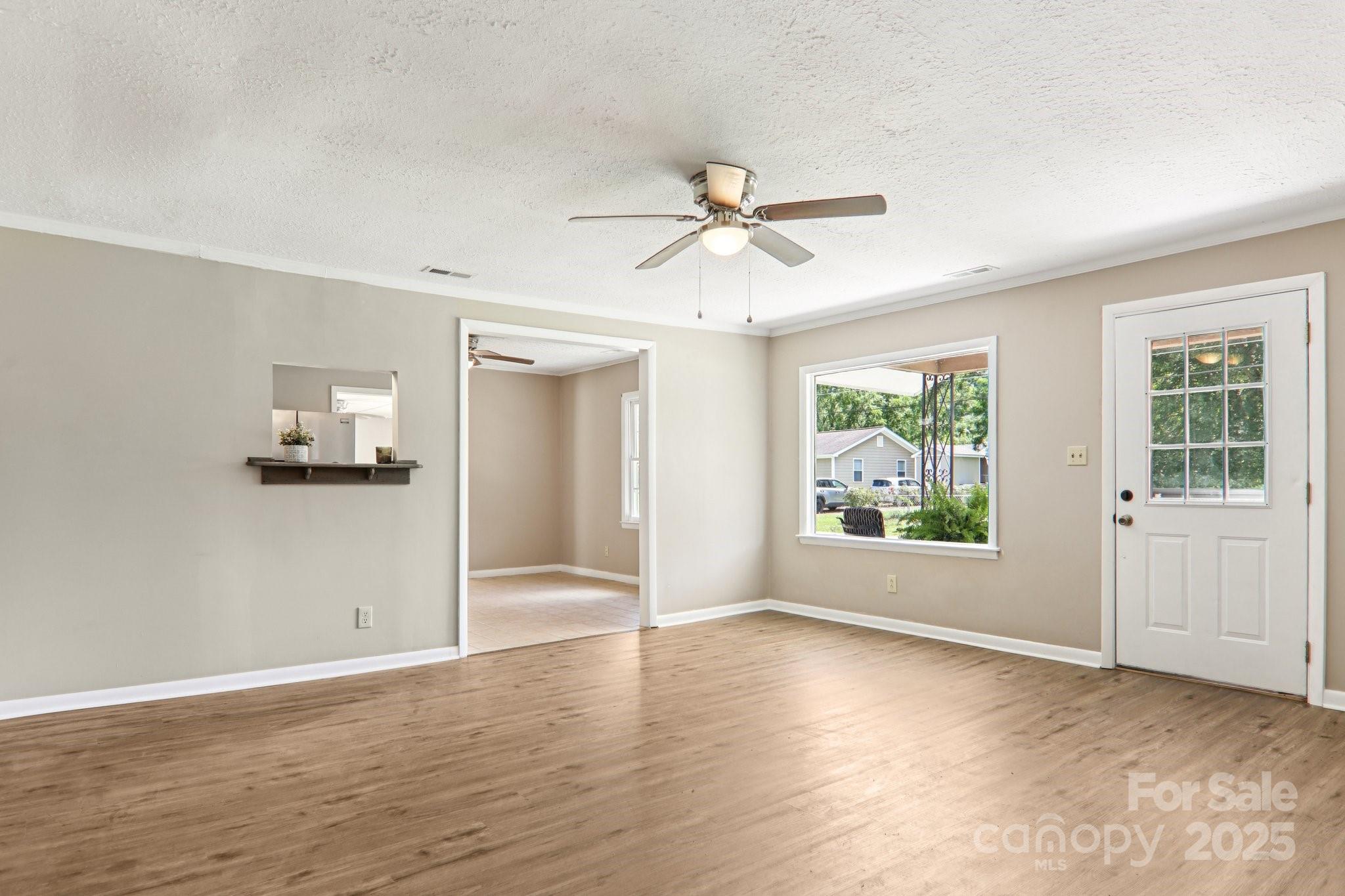 55 Polk Street Waynesville, NC 28786 - Photo 10 of 44 a view of n empty room with a window and wooden floor