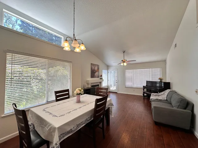 a view of a dining room with furniture window and wooden floor