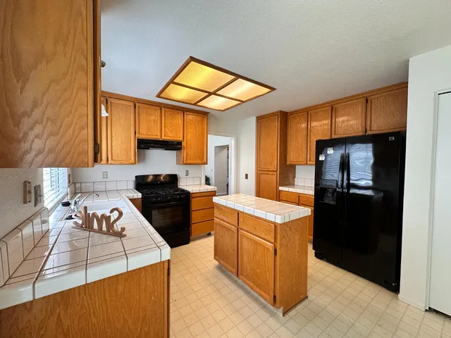 a kitchen that has a cabinets and a stove top oven