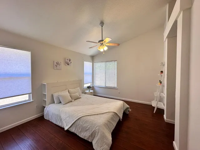 a bedroom with a bed and a window