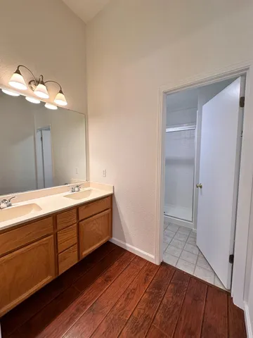 a bathroom with a double vanity sink and a mirror
