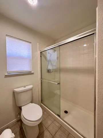 a bathroom with a shower and toilet