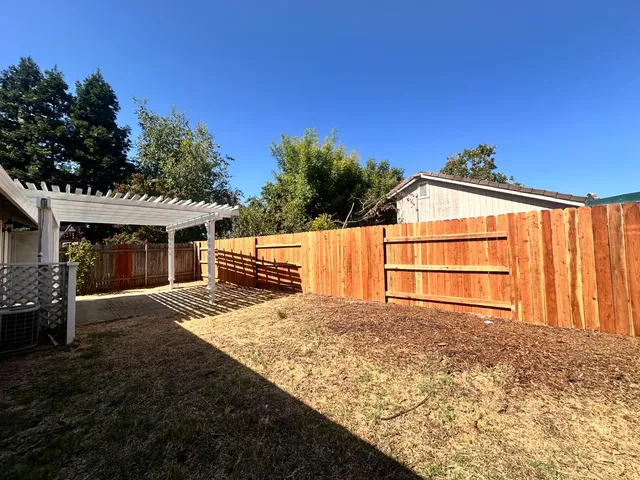 a view of backyard with seating space and deck