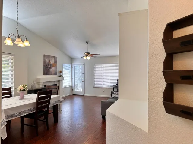 a view of a dining room with furniture and wooden floor