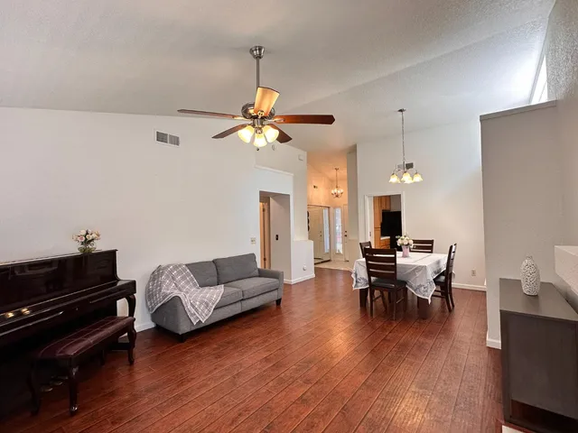 a living room with furniture and wooden floor