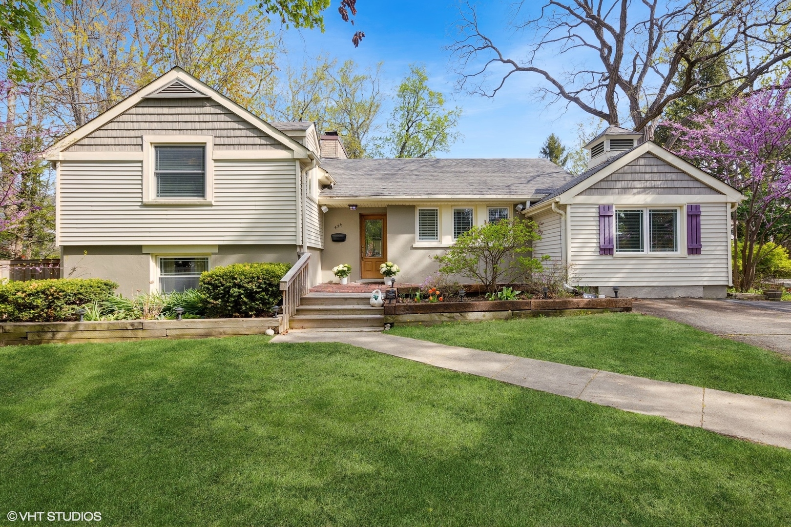 a front view of a house with a yard and trees