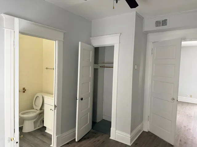 a bathroom with a granite countertop toilet and a shower