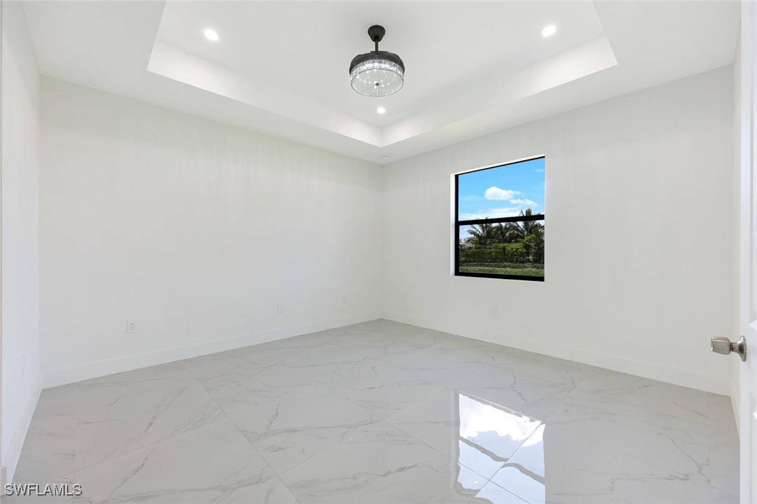 147 Partridge Street Lehigh Acres, FL 33974 - Photo 11 of 20 an empty room with wooden floor and ceiling fan