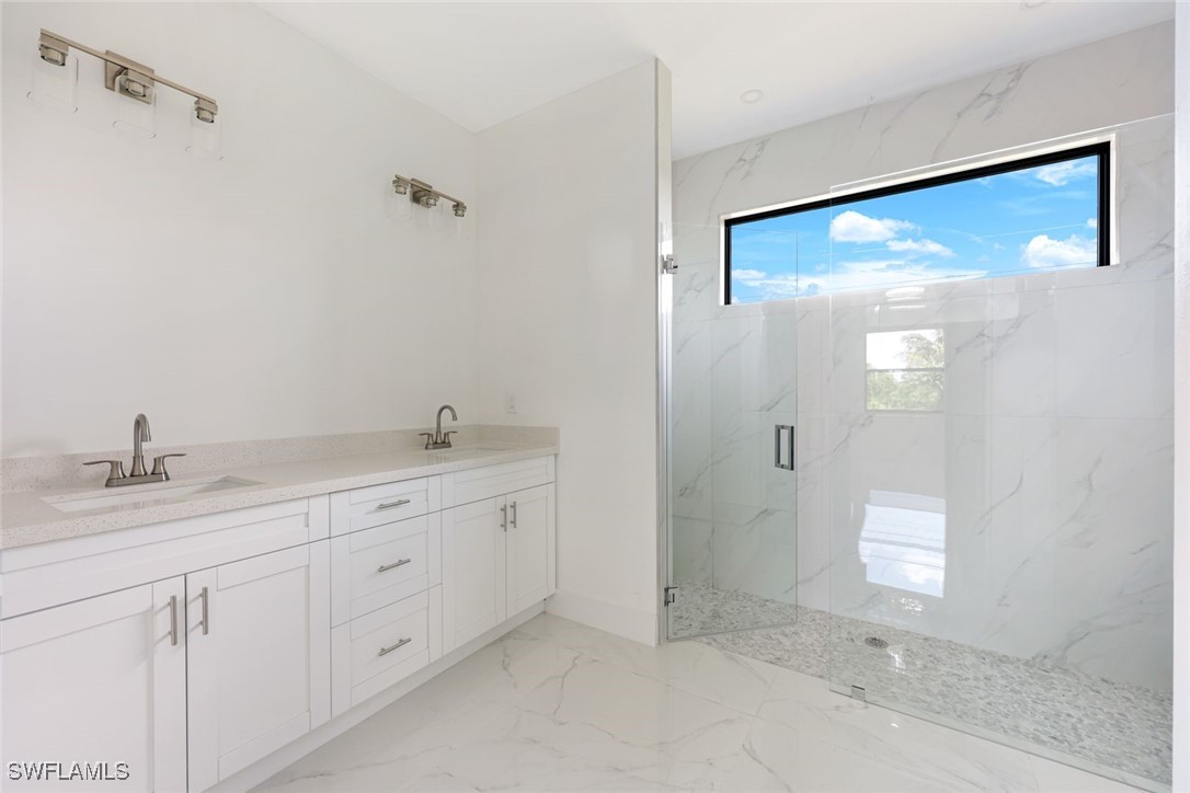 147 Partridge Street Lehigh Acres, FL 33974 - Photo 13 of 20 a bathroom with a granite countertop sink mirror and