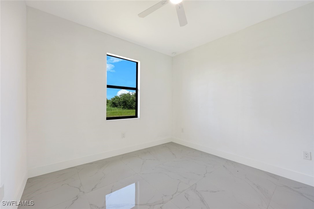 147 Partridge Street Lehigh Acres, FL 33974 - Photo 14 of 20 an empty room with a window
