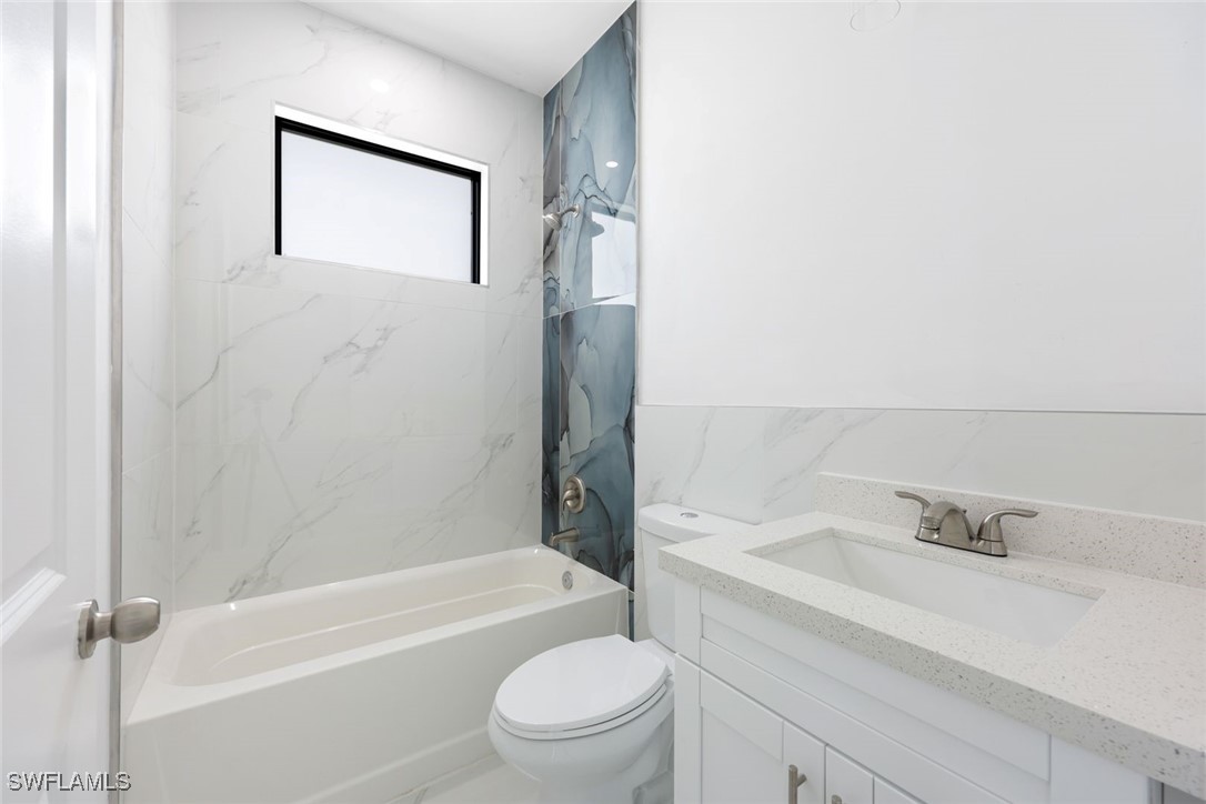 147 Partridge Street Lehigh Acres, FL 33974 - Photo 15 of 20 a bathroom with a sink a toilet and shower