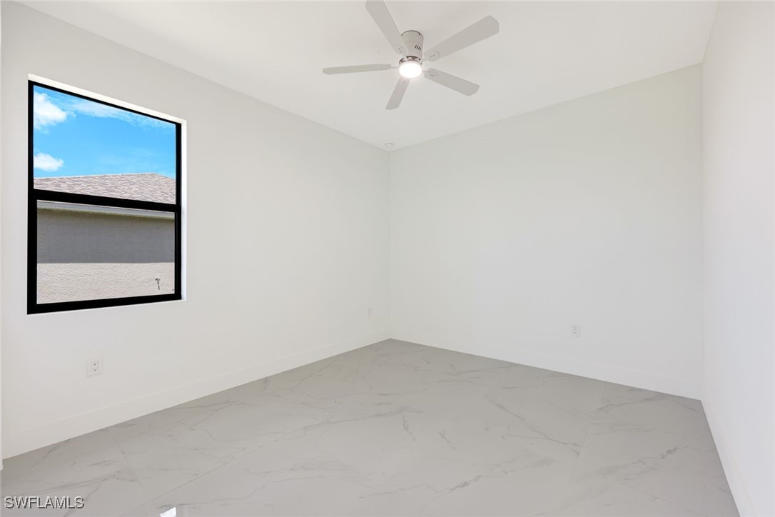 147 Partridge Street Lehigh Acres, FL 33974 - Photo 16 of 20 an empty room with a ceiling fan and a window