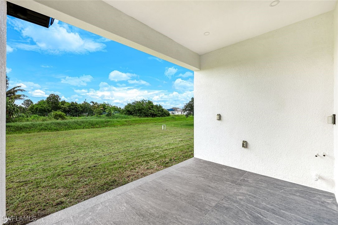 147 Partridge Street Lehigh Acres, FL 33974 - Photo 19 of 20 a view of a big room with wooden floor and fence
