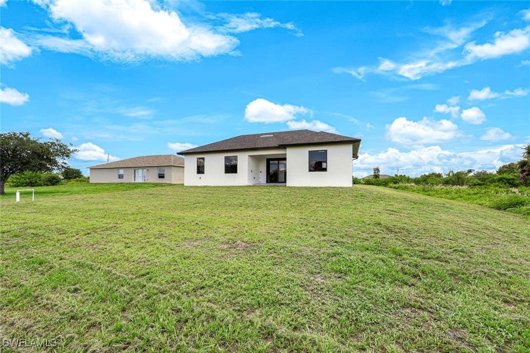 147 Partridge Street Lehigh Acres, FL 33974 - Photo 20 of 20 a view of a house with a yard