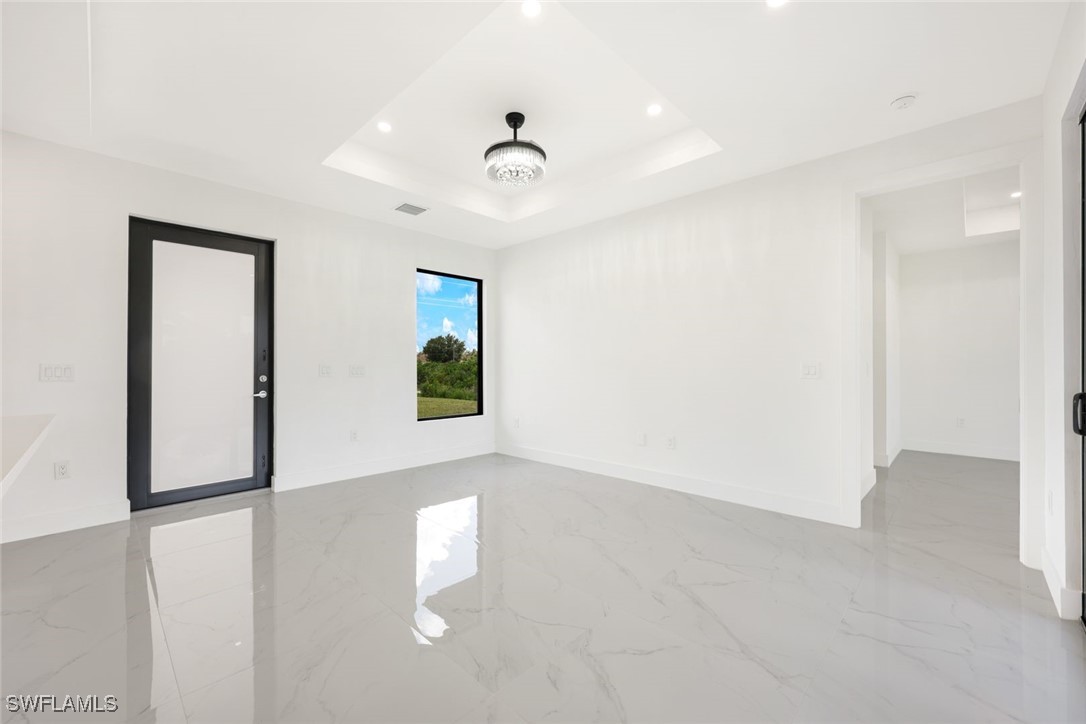 147 Partridge Street Lehigh Acres, FL 33974 - Photo 6 of 20 wooden floor in an empty room with a window