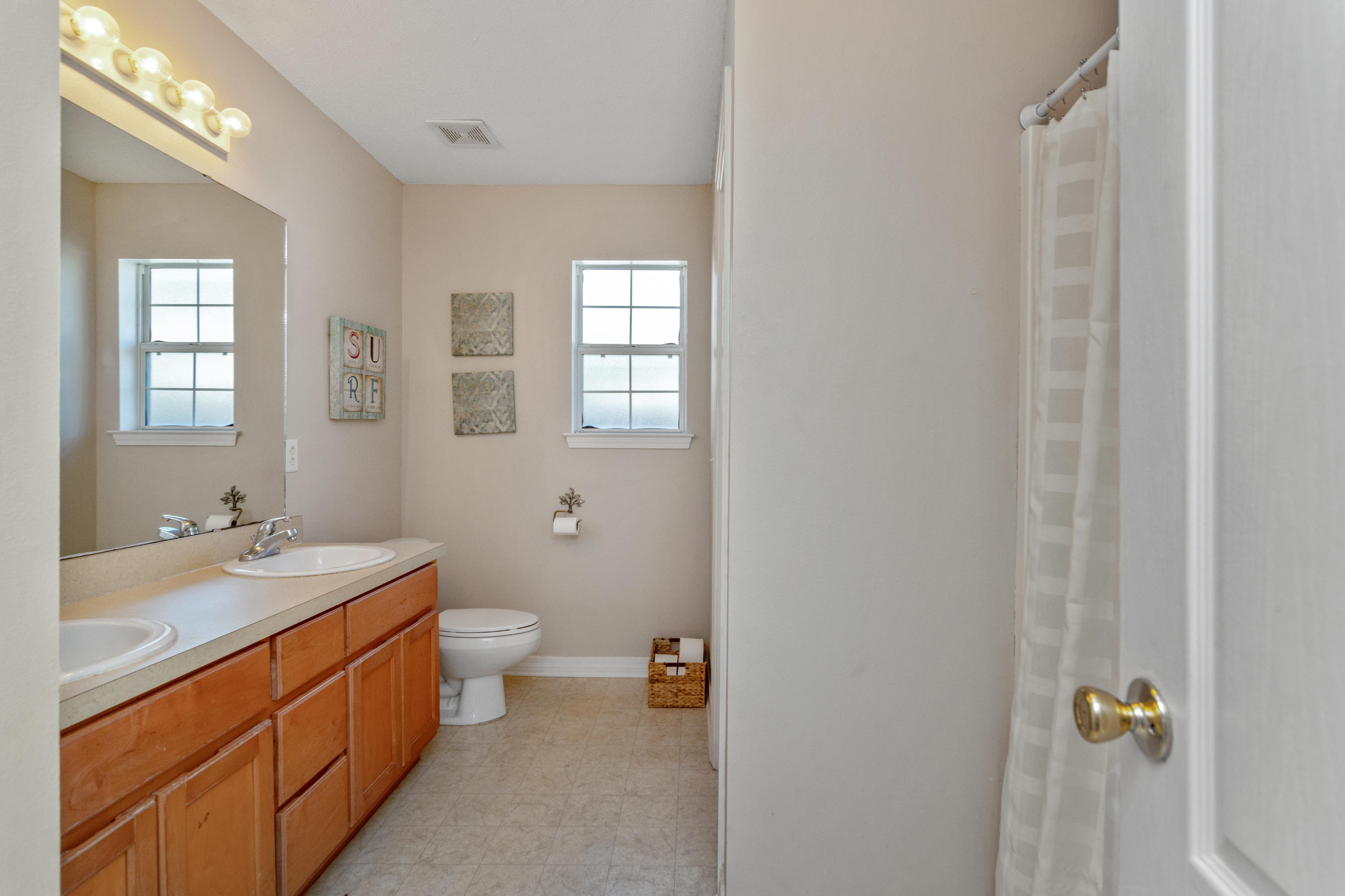 1845 Brick Circle Fort Walton Beach, FL 32547 - Photo 13 of 24 a bathroom with a double vanity sink toilet and a mirror