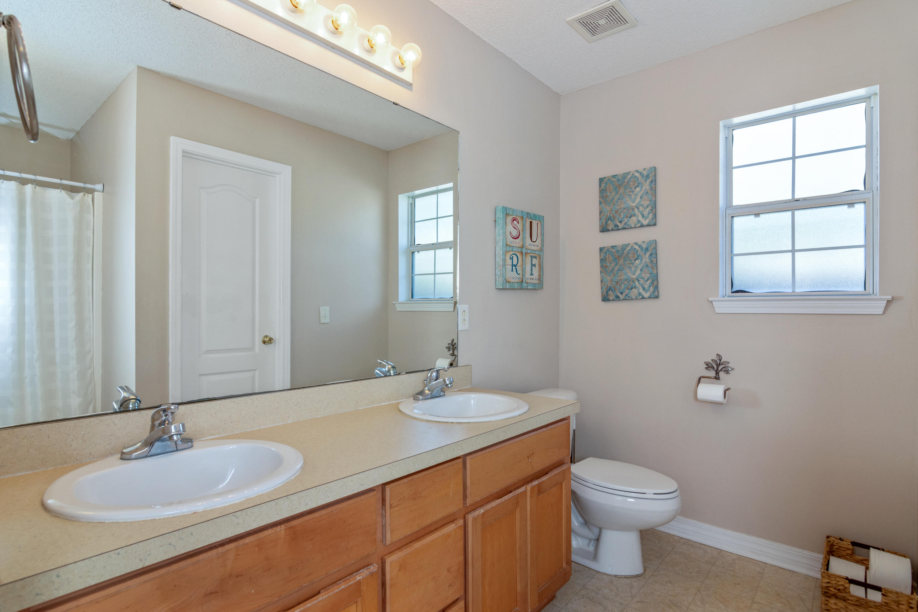 1845 Brick Circle Fort Walton Beach, FL 32547 - Photo 14 of 24 a bathroom with a granite countertop sink toilet and mirror