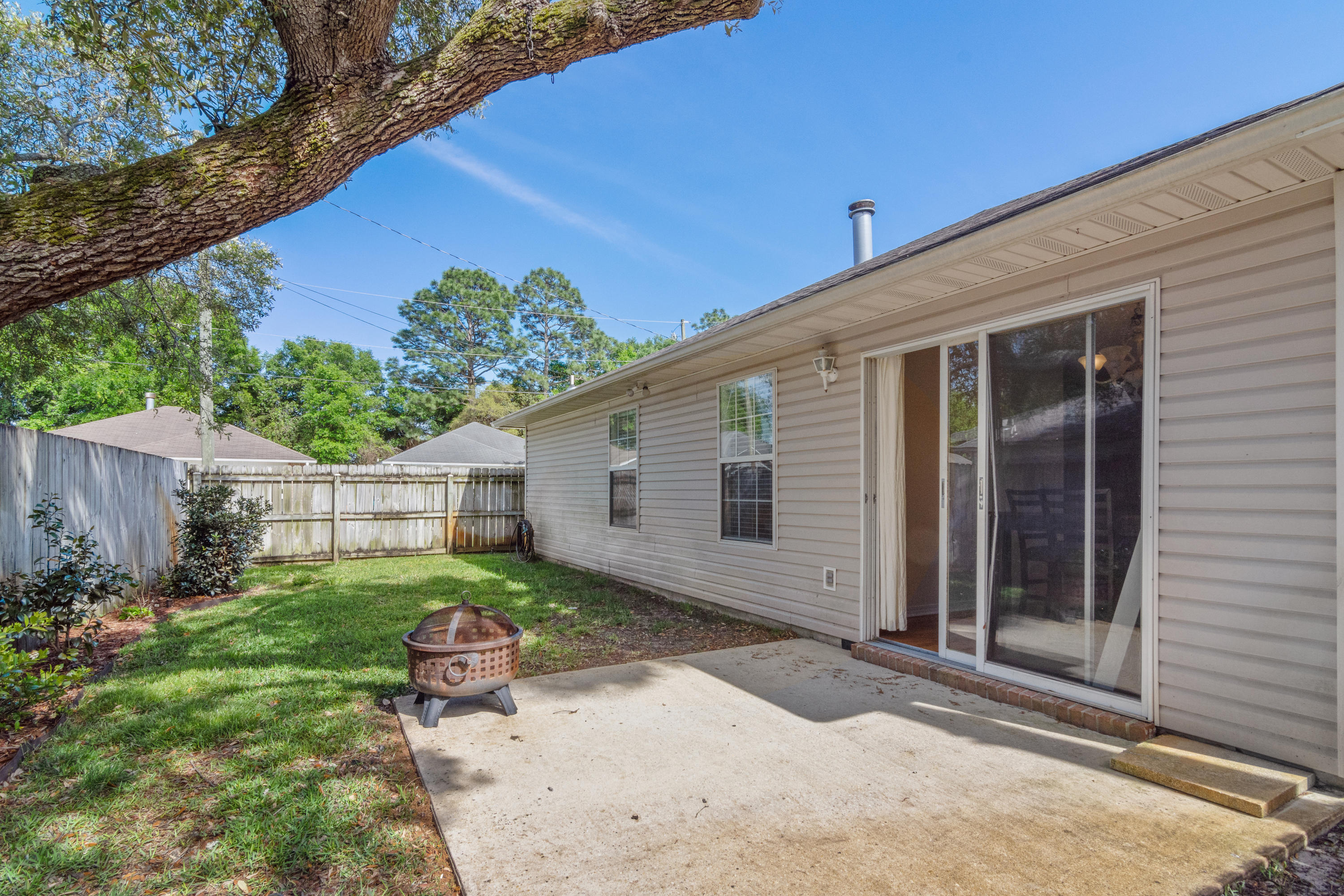 1845 Brick Circle Fort Walton Beach, FL 32547 - Photo 23 of 24 a backyard of a house with yard and outdoor seating