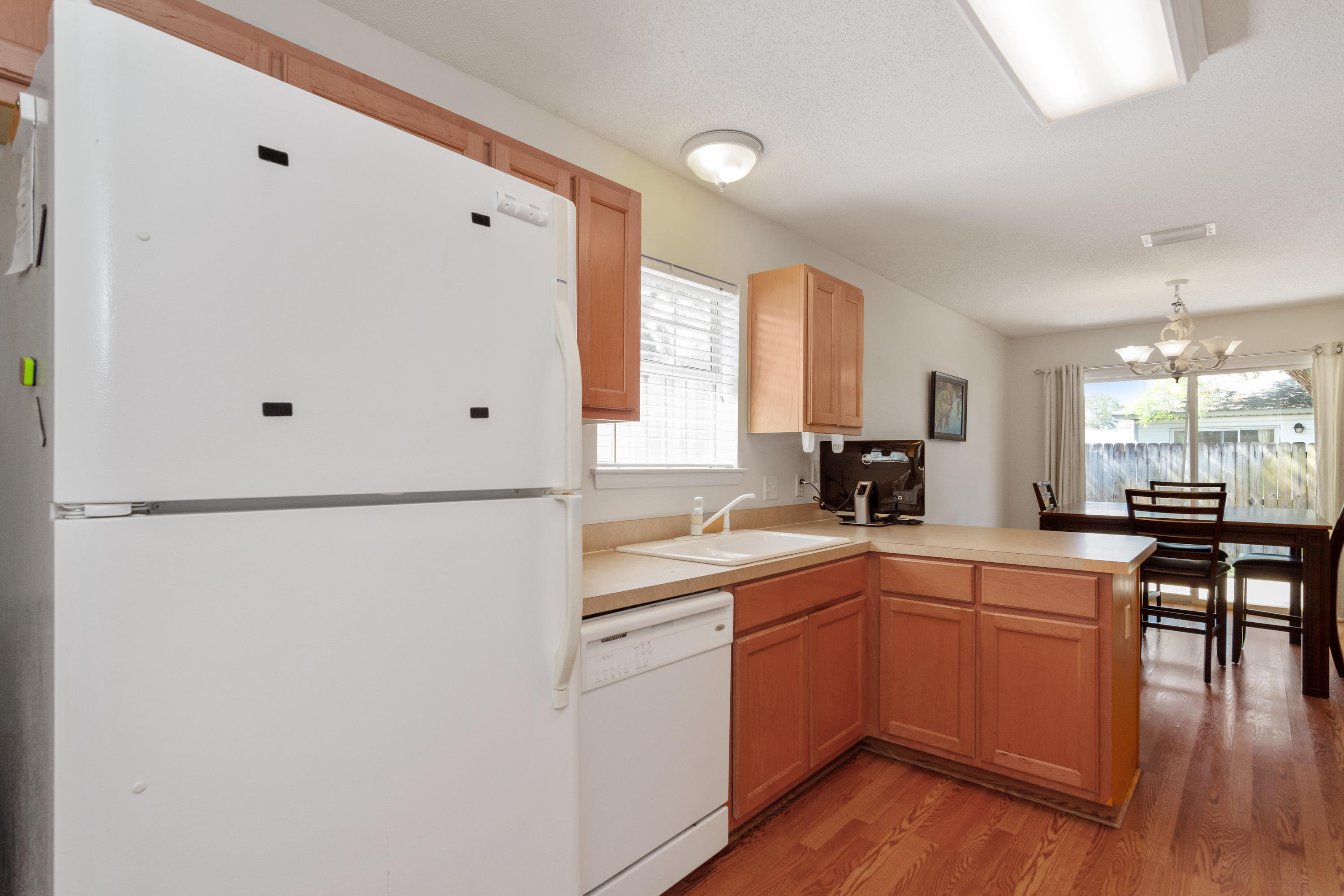 1845 Brick Circle Fort Walton Beach, FL 32547 - Photo 8 of 24 a kitchen with a sink a refrigerator and wooden floor